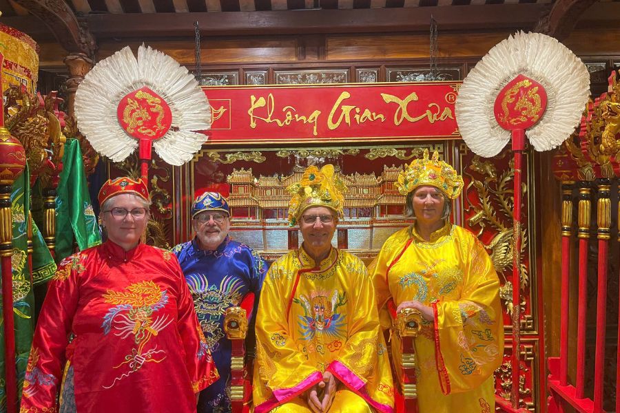 Foreign guests celebrating Vietnamese culture by wearing royal traditional costumes at a heritage site