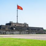 Luxury Vietnam Itinerary visit to Hue Flag Tower at Imperial City under blue sky
