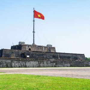Luxury Vietnam Itinerary visit to Hue Flag Tower at Imperial City under blue sky