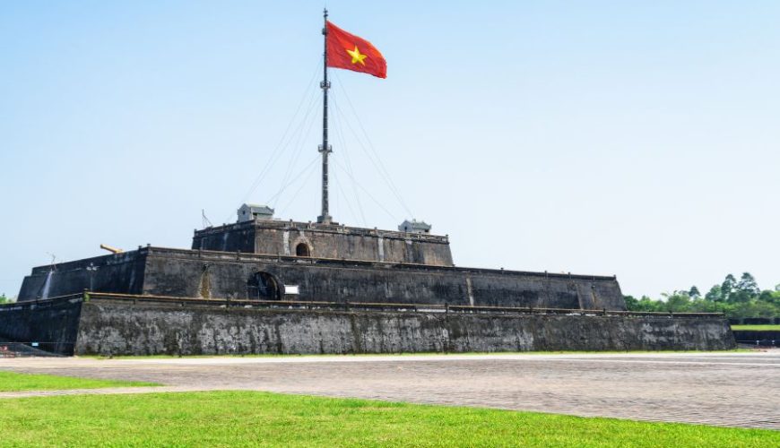 Luxury Vietnam Itinerary visit to Hue Flag Tower at Imperial City under blue sky