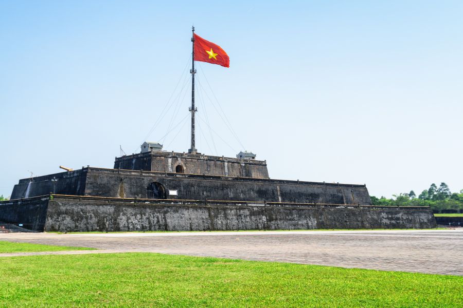Luxury Vietnam Itinerary visit to Hue Flag Tower at Imperial City under blue sky