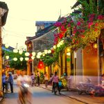Luxury Vietnam Tour evening walk in Hoi An Ancient Town with lantern lights and flowers