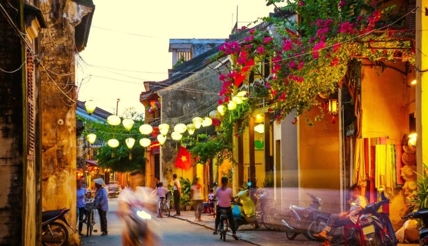 Luxury Vietnam Tour evening walk in Hoi An Ancient Town with lantern lights and flowers