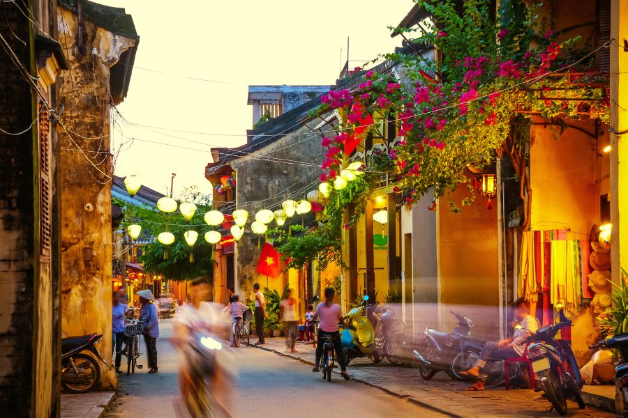 Luxury Vietnam Tour evening walk in Hoi An Ancient Town with lantern lights and flowers