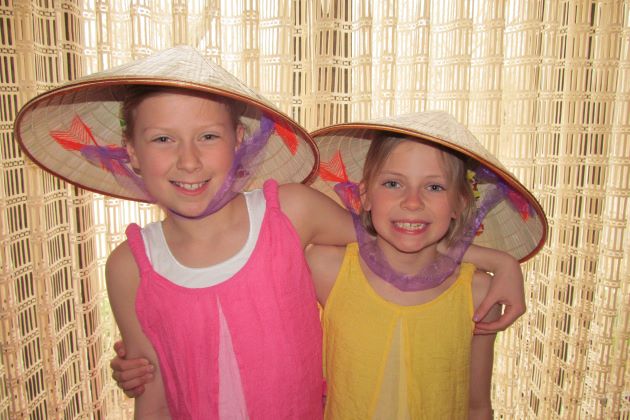 kids with conical hats luxury tour company in southeast asia