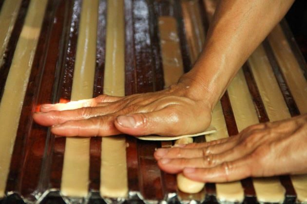 making coconut candy in mekong delta